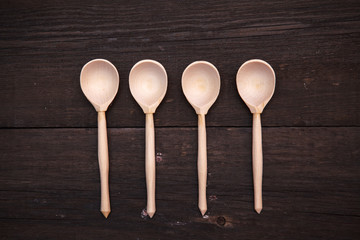 wooden spoons on a wooden background