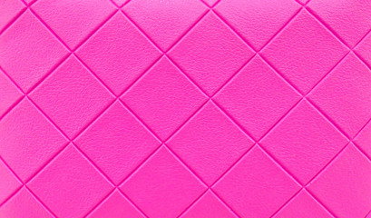 Leather texture  with seamless sewing  thread diamond square shape pattern in pink color for background.