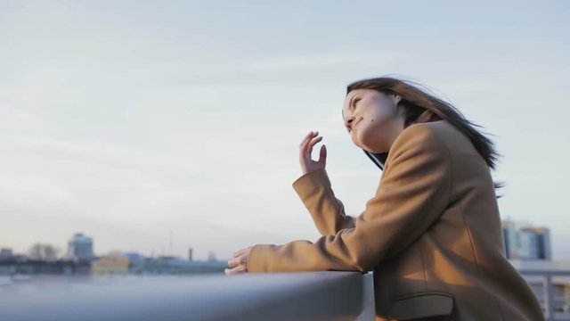 Relaxed girl looking forward at sunset in city