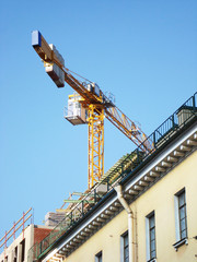 Fototapeta na wymiar Construction crane on background of blue sky