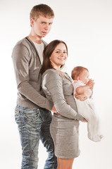 Happy family with child posing on white background