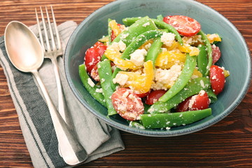 Snow pea salad with feta, tomato and pepper