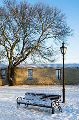 Bench and street lamp in the park, winter
