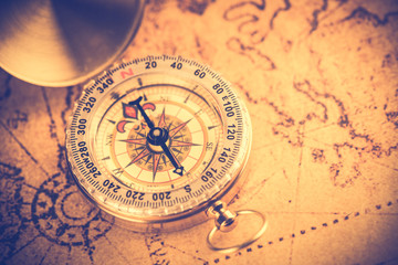 Old  gold vintage compass on vintage map:Heading south ,vintage tone style