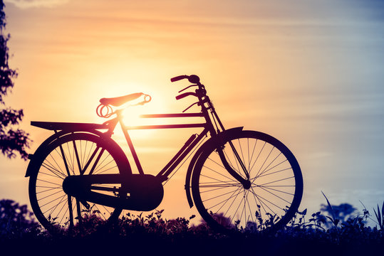 beautiful landscape image with Silhouette classic Bicycle at sunset