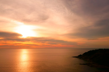 Beautiful Tropical Sunset Scene in the Sea. Phuket Lam Phromthep. Sun and Cloud Background.