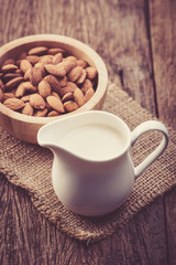Obraz na płótnie Canvas Almond milk in glass with almonds