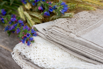 Shot of linen tablecloth with lace trim and flowers

