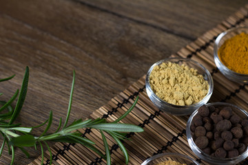 bowls of various spiceson black background, 