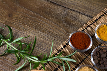 bowls of various spiceson black background, 