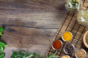 bowls of various dip sauces on black background, top view