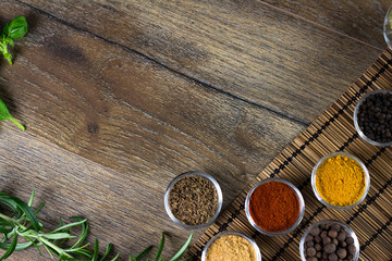 bowls of various dip sauces on black background, top view