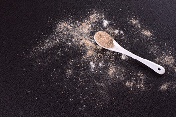 White whole-wheat flour and a spoon