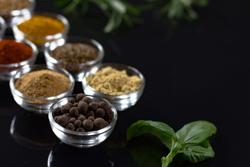 bowls of various dip sauces on black background, 