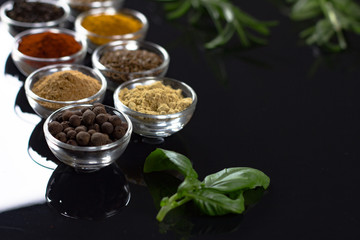 bowls of various dip sauces on black background, 