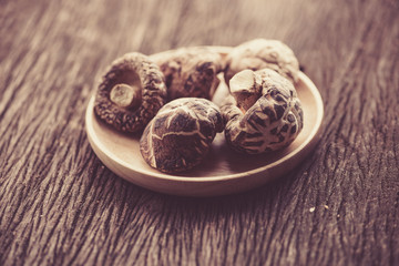 dried shiitake mushroom in wood bowl