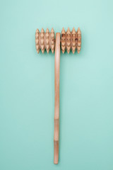Wooden massager with spikes for the body on a paper background