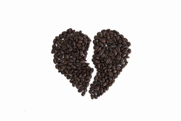 broken heart from coffee beans isolated on a white background