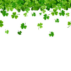 Vector St. Patrick's day horizontal seamless background with green falling shamrock on white.