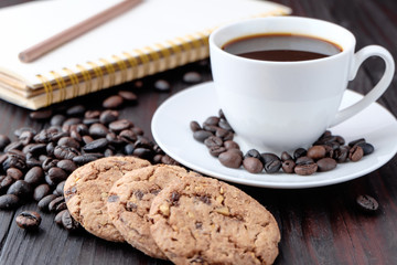 Coffee cup and coffee beans on wooden background