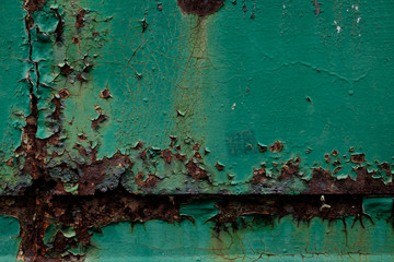 Green metal parts with rust spots and corrosion