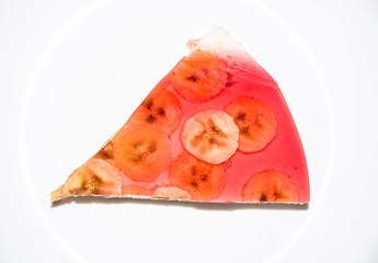 Cottage cheese cake with banana slices and gelatin on isolated background