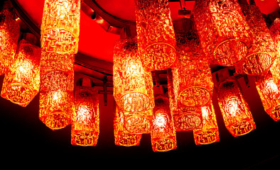 top view to part of round decorative modern shaped lamps on ceiling against dark background