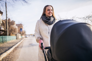 young mother walking with baby, good weather for walking, healthy lifestyle