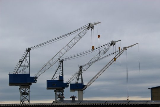 Cranes of a shipyard in the coastal town Haugesund, Norway, on the island Risoy. Scandinavia, Europe.