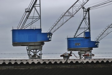 Cranes of a shipyard in the coastal town Haugesund, Norway, on the island Risoy. Scandinavia, Europe.
