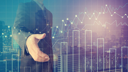 Businessman offering for handshake with cityscape and financial graph on blurred building background, Business Trading concept,Forex graph