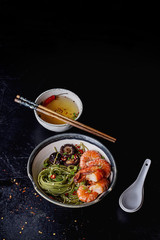 Green tea soba noodles  served with shrimps,  shiitake mushrooms and spicy broth.  Decorated with different spices and condiments used during preparation