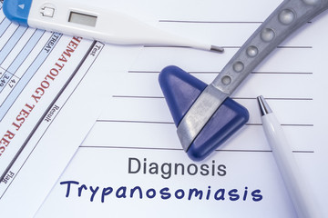 Diagnosis Trypanosomiasis. Paper medical report written with neurological diagnosis of trypanosomiasis is surrounded by a neurological reflex hammer, electronic thermometer and common blood test