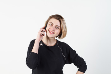 Businesswoman talking on the phone very emotional. She smile, anger, aggression, misunderstood, outrage. On a white background. Happy smiling successful businesswoman with cell phone, isolated on