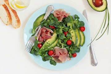 Salad with avocado, jamon and cherry tomatoes.Selective focus