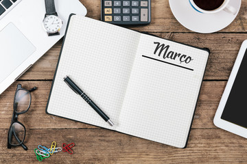 Marco (Portuguese March) month name on paper note pad at office desk