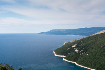 High aerial view to sea bay, peninsula and mountain in Opatija. Croatian seascape with lagoon and hiils.