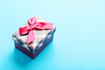 Gift box with ribbon on blue background