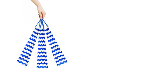 Obraz premium Woman hand holding blue shopping bags on white background, clipping path