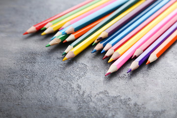 Drawing colourful pencils on grey wooden table