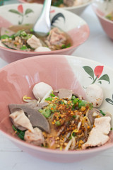 Thai Fusion Food, dry noodle with pork in ceramic bowl