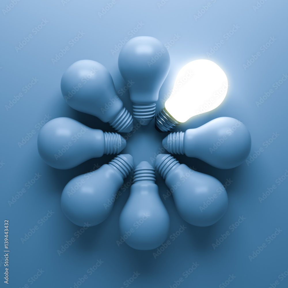 Poster one glowing light bulb standing out from the unlit incandescent bulbs on blue background with shadow