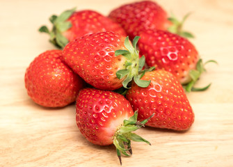 Red Strawberry on Wooden Plate Closeup shot