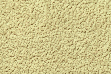 Yellow fluffy background of soft, fleecy cloth. Texture of textile closeup