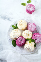 Homemade marshmallows on a light background. Russian currant and mango zephyr. Selective focus.Top view.