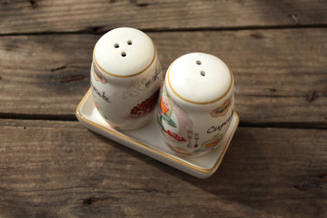 Salt and pepper shakers on rustic wooden table