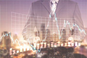 Double exposure of success businessman using digital tablet with city landscape background and forex graph.