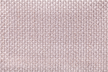 Pink background with checkered pattern, closeup. Structure of the fabric macro.
