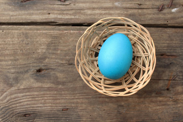 Easter egg on old wooden background with copy space 