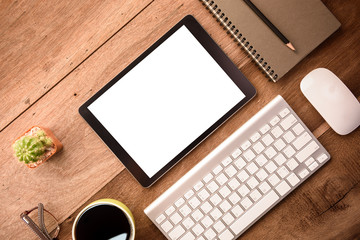 mockup tablet similar to ipad style on wood desk white display.keyboard and office stuff, workplace, top view